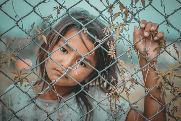 Girl behind fence